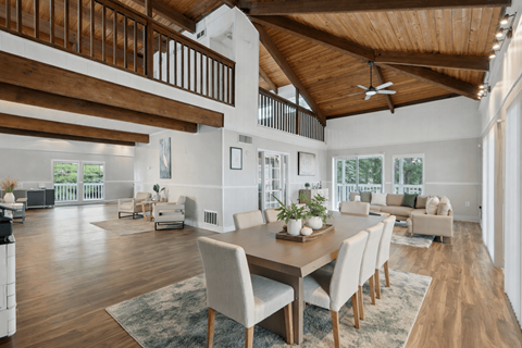 A modern dining room with a wooden table and chairs.