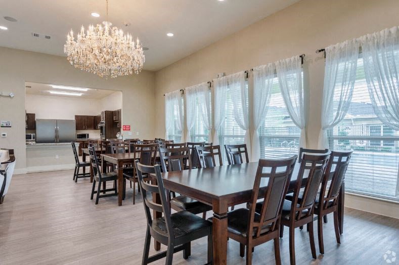 a dining room with a large table and chairs