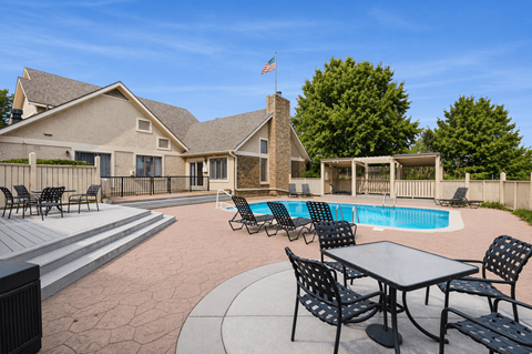 A house with a pool and a flag on the roof.