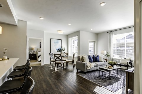 A modern living room with a grey couch and a coffee table.