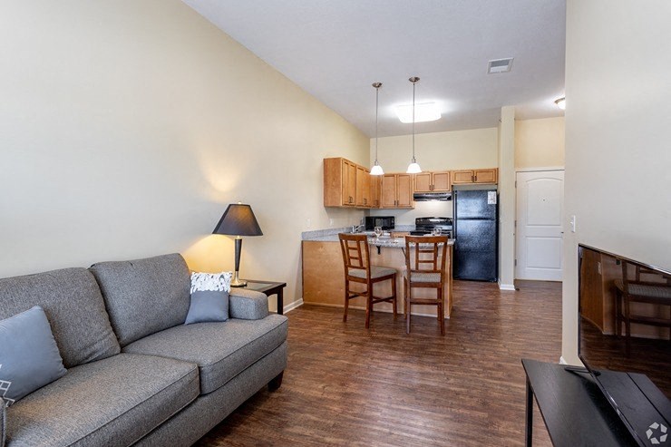 Living Room With Kitchen View at The Gardens at Jackson Creek, Independence, MO, 64057