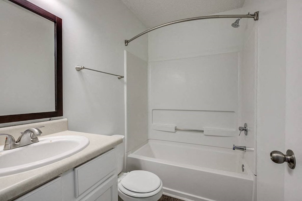 a bathroom with a sink toilet and a bath tub