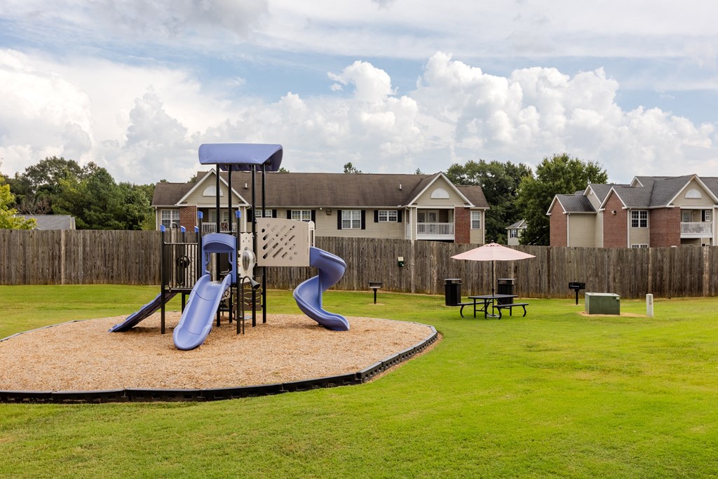 our apartments have a playground with slides and a picnic table