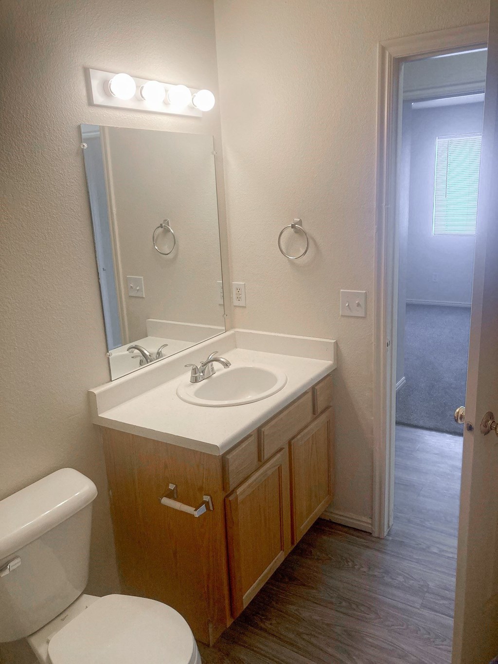 a bathroom with a sink toilet and a mirror