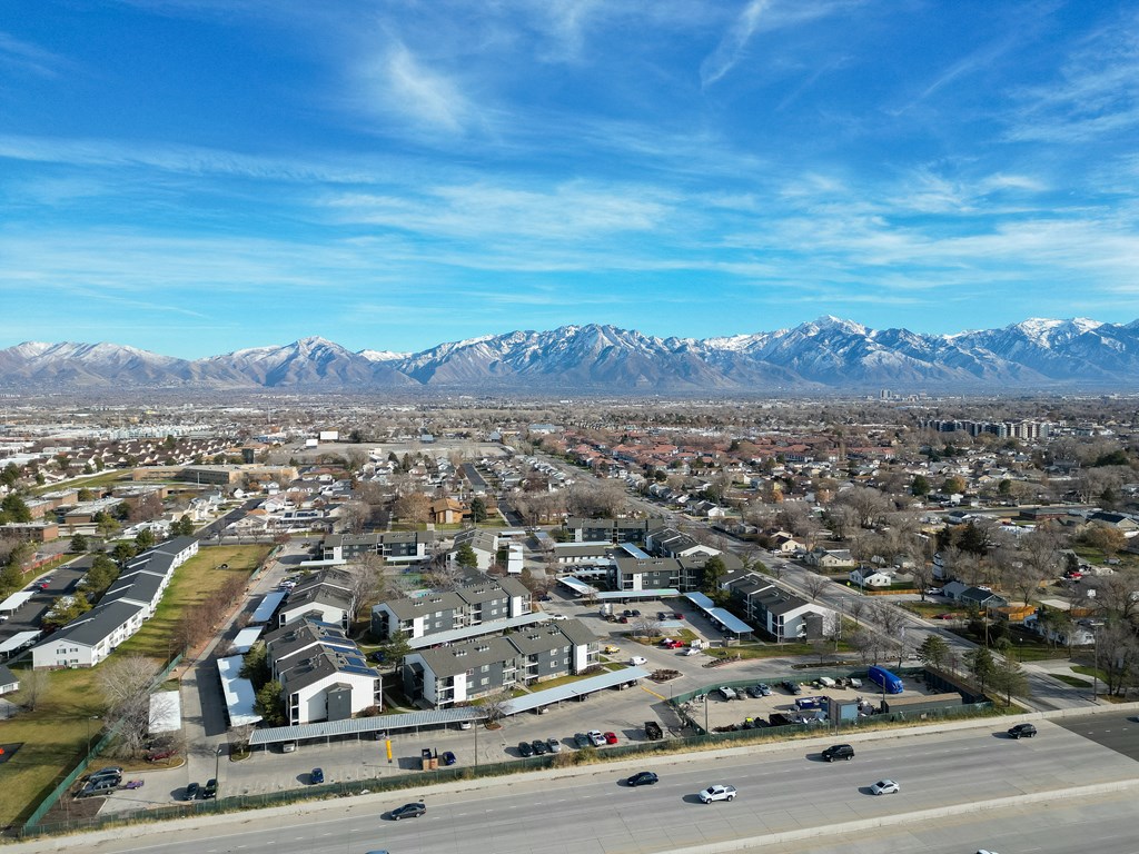 an aerial view of a city with mountains in the background