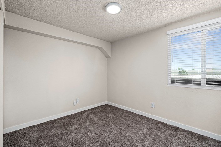a bedroom with a large window