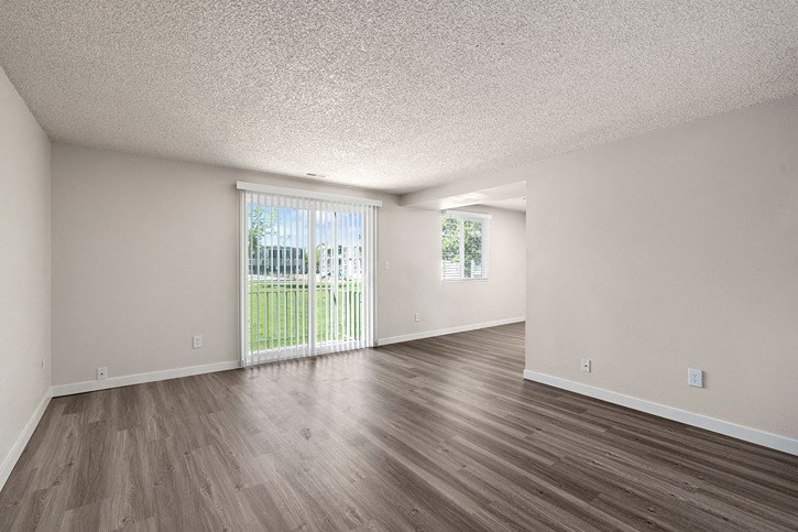 an empty living room with a sliding glass door