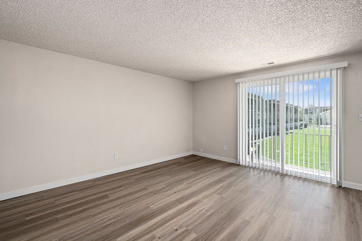 an empty room with a sliding glass door