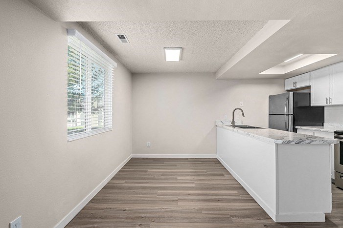 an empty kitchen with a large window