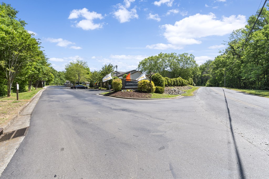 an empty street with a house on the corner of a road