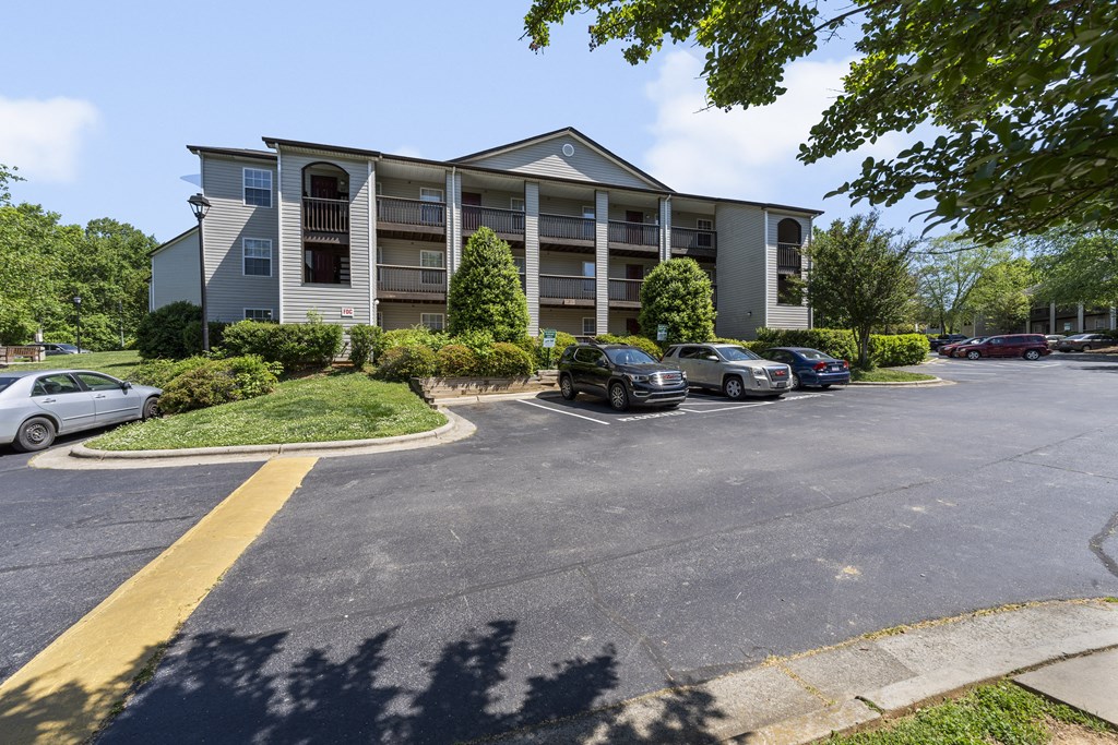 an apartment building with cars parked in front of it