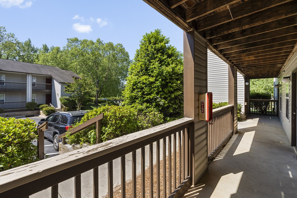 the view of the street from the front porch of a house