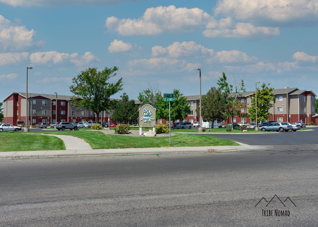 a street corner with a street sign in front of an apartment building