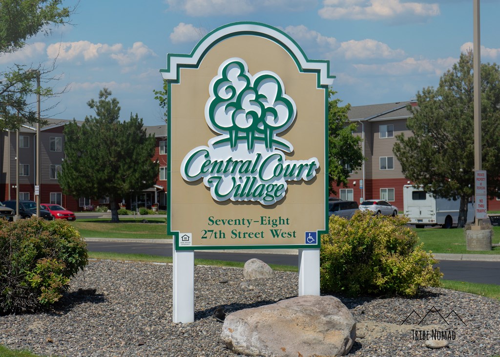 the sign for central court village in front of an apartment community