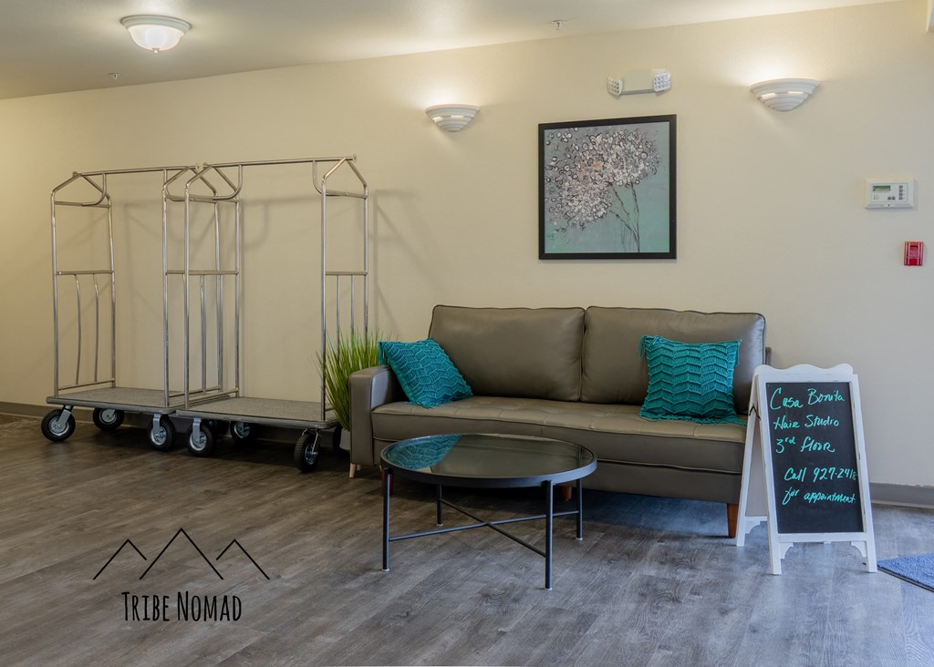 a living room with a couch and a chalkboard in the corner