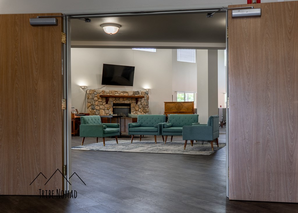 a living room with a fireplace and a couch and chairs