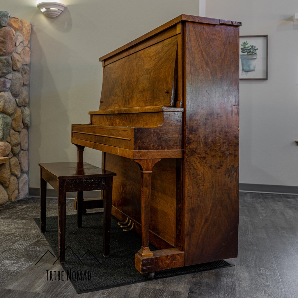 a piano in a living room with a stool