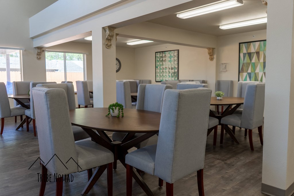 a dining room with tables and chairs in a building