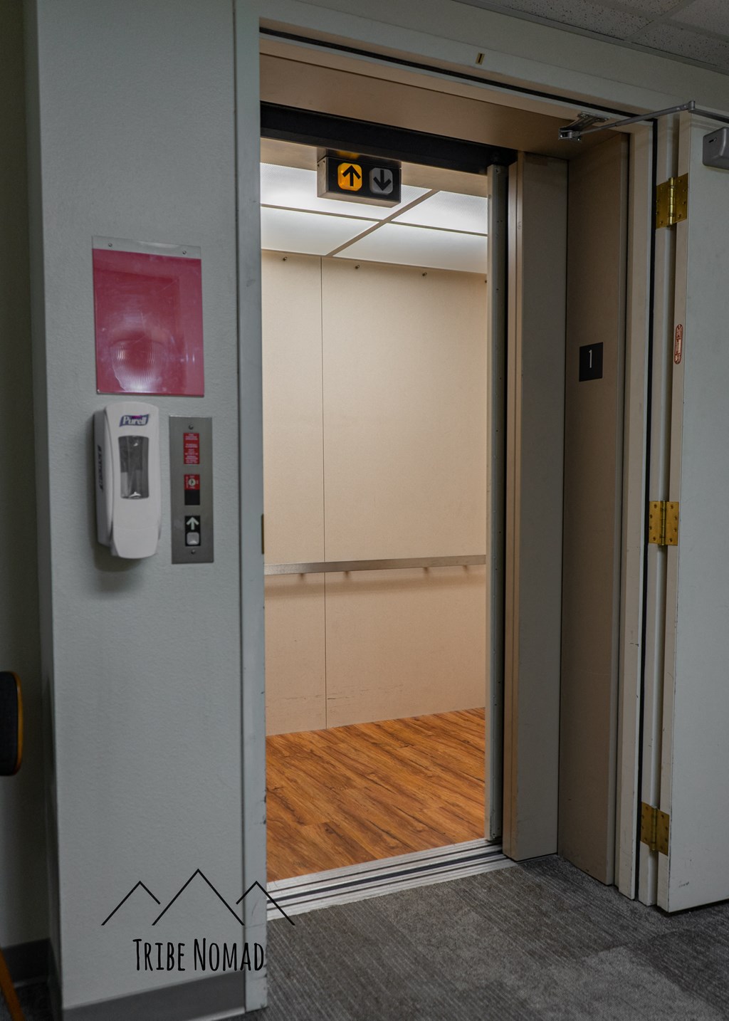 a door to a room in a building with a wood floor