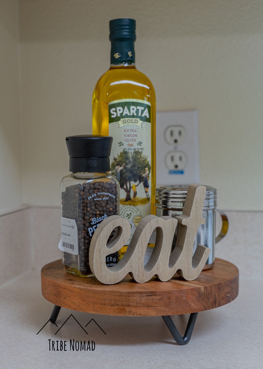 a wooden tray with a bottle of olive oil and other ingredients on it