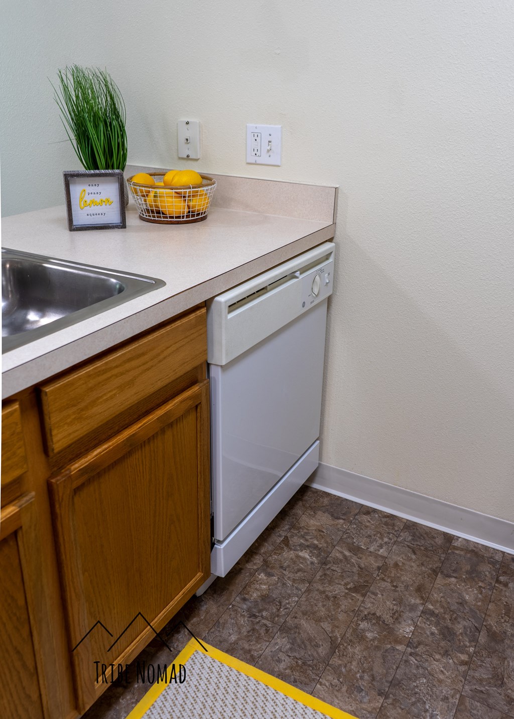 the kitchen has a washer and dryer and a sink