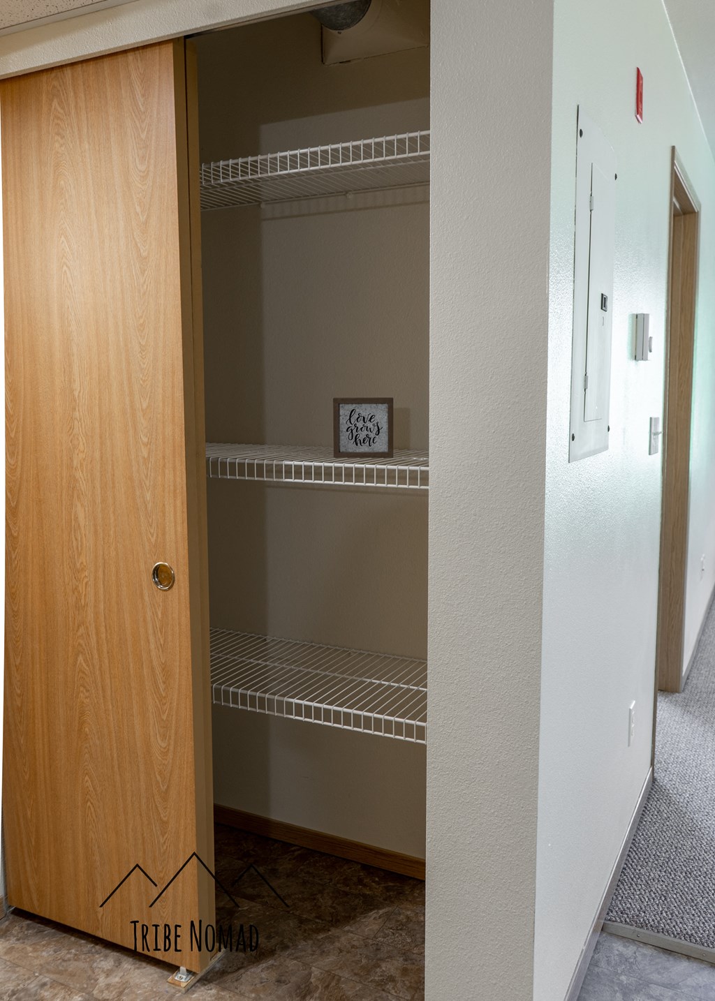 a closet with shelves and a clock on the wall