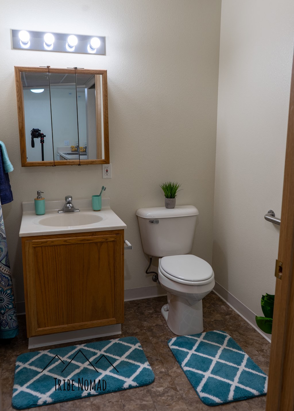 a small bathroom with a toilet sink and mirror