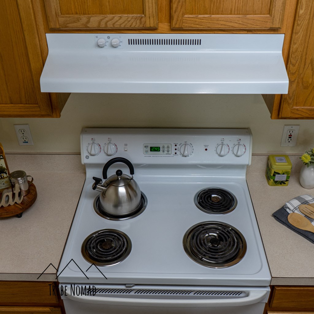 a white stove top oven with a kettle on top of it