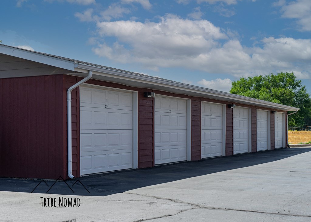 a row of white garage doors on the side of a building