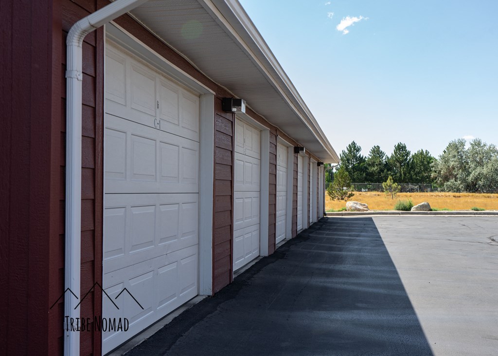 a row of white garage doors on the side of a building