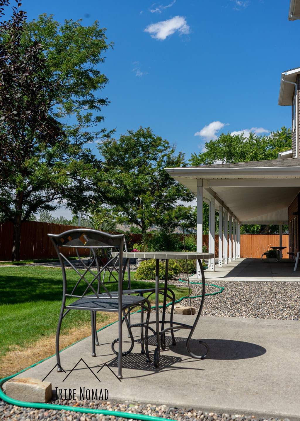 a patio with a table and chairs on it