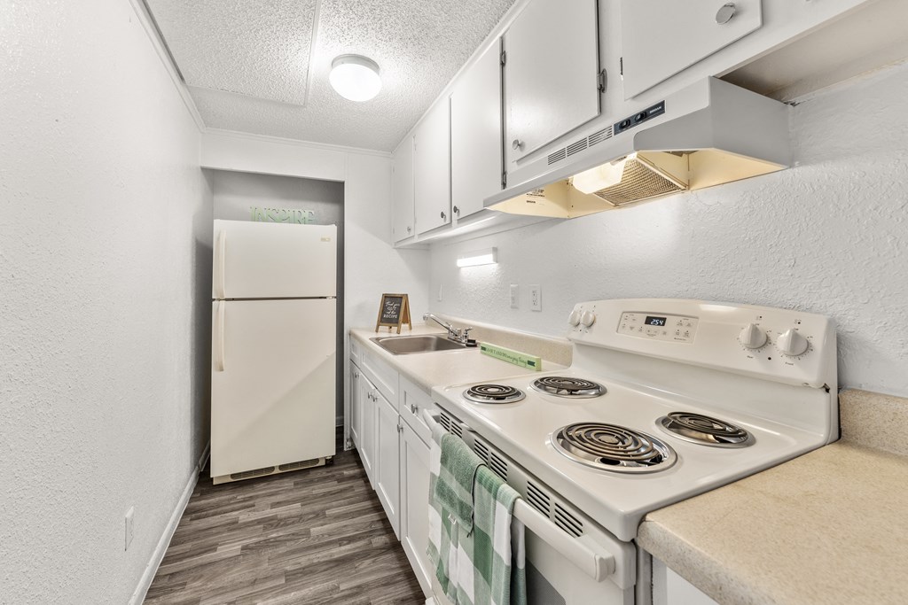 a kitchen with white appliances and a white refrigerator