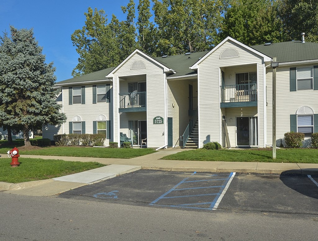 an apartment building with a fire hydrant in front of it