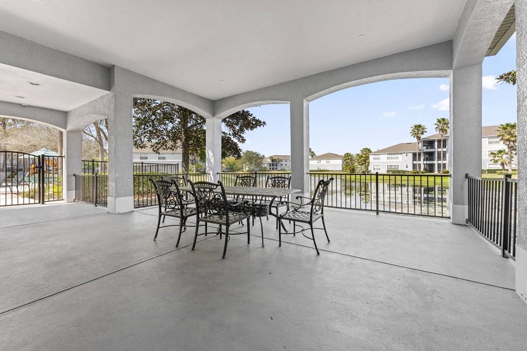 a patio with chairs and a table on a patio