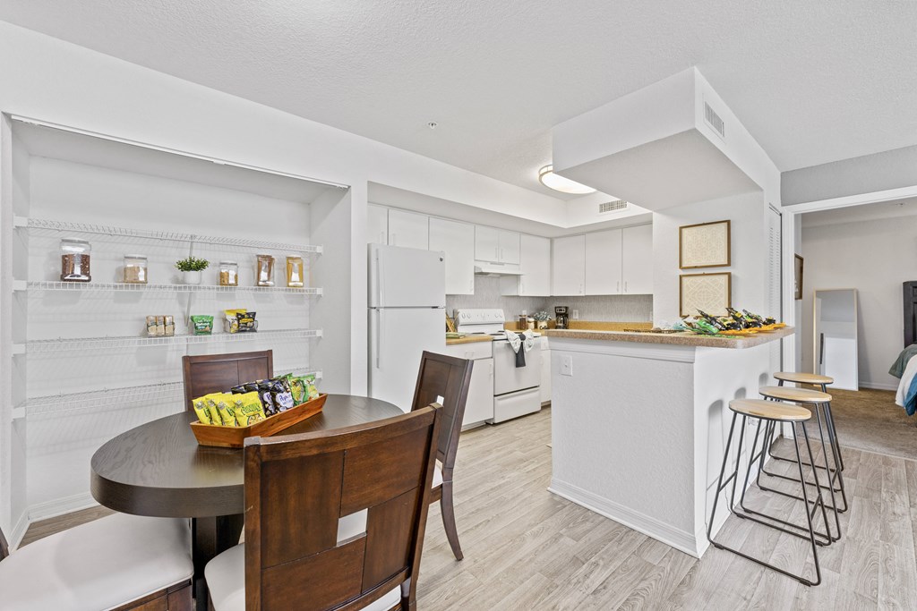 a living room with a kitchen and a dining table