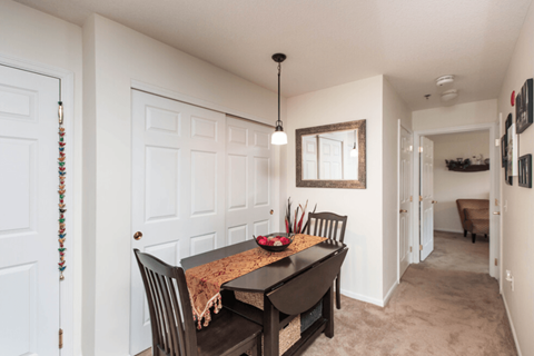 an empty dining room with a table and chairs
