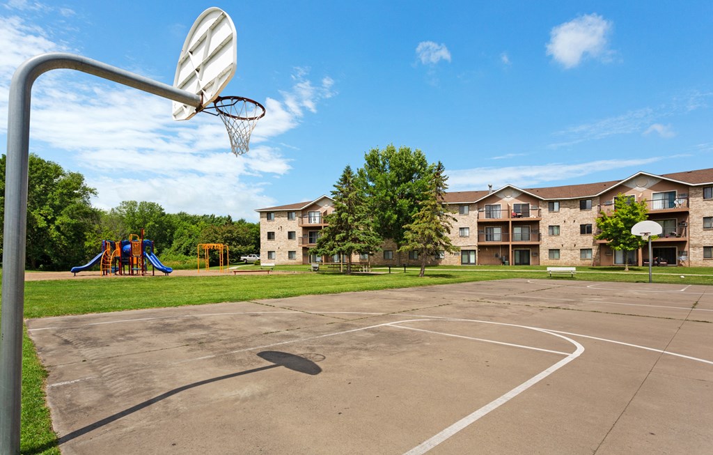 an outdoor basketball court at the enclave at green valley apartments