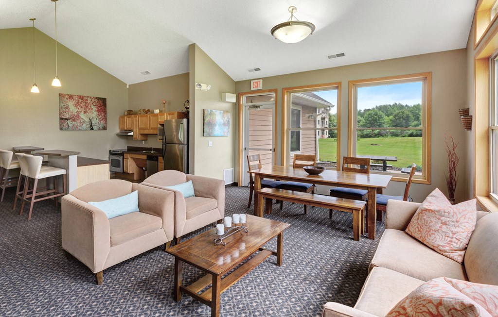 a living room with couches and chairs and a dining room table