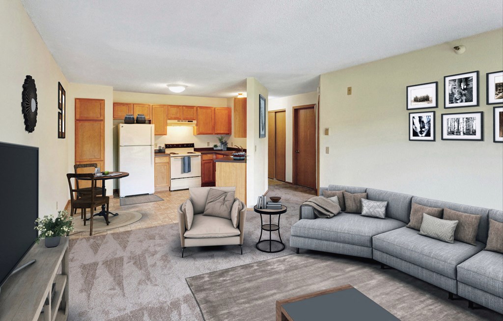 a living room with a couch and a chair and a kitchen