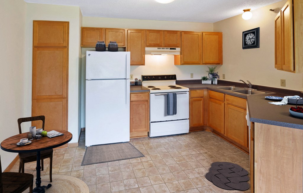 a kitchen with white appliances and wooden cabinets