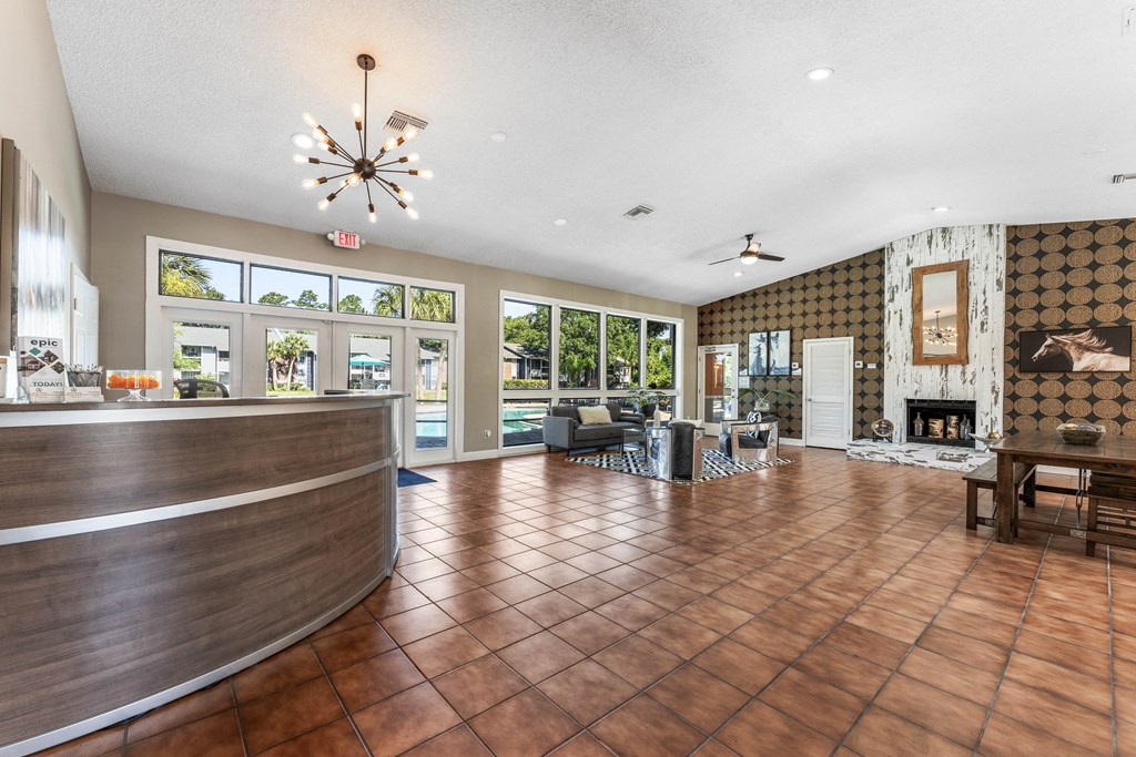 a lobby with a reception desk and a fire place