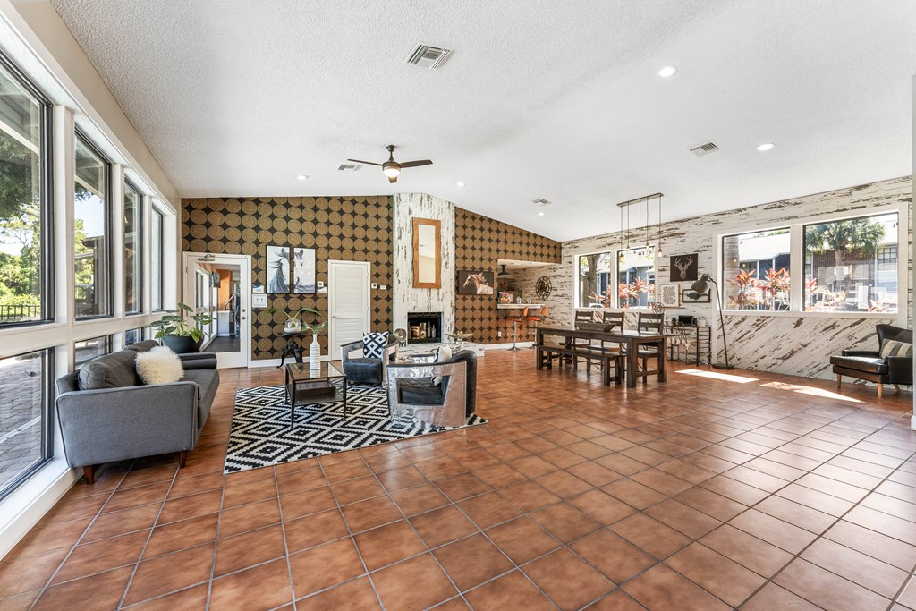 a living room with a fireplace and a table and chairs