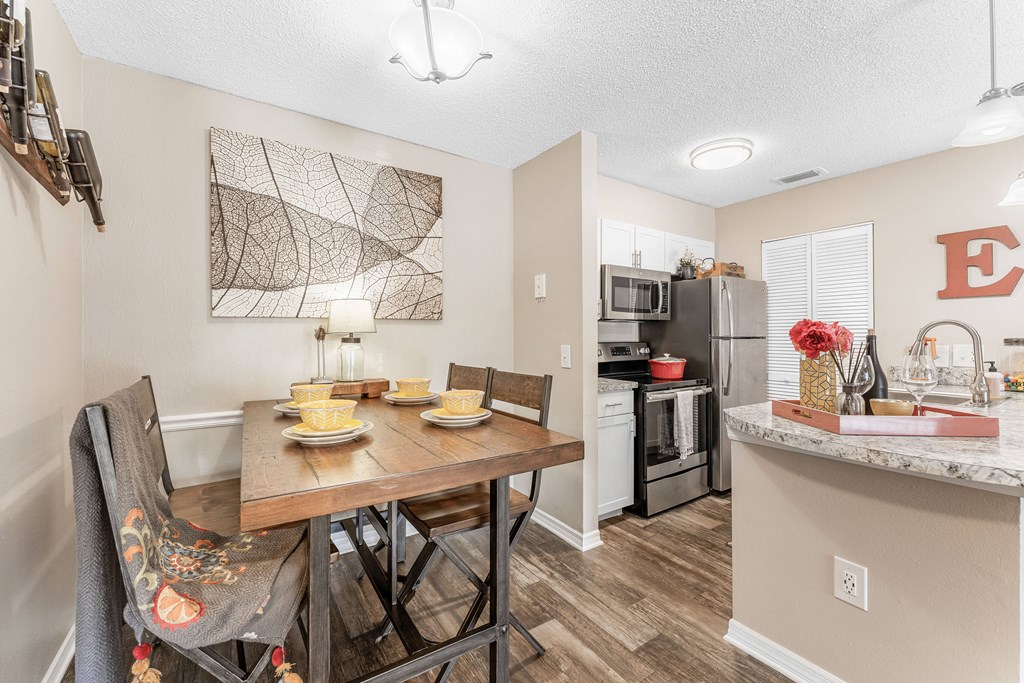 an open kitchen and dining room with a table and chairs