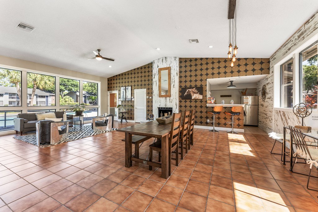 a living room and dining room with a table and chairs