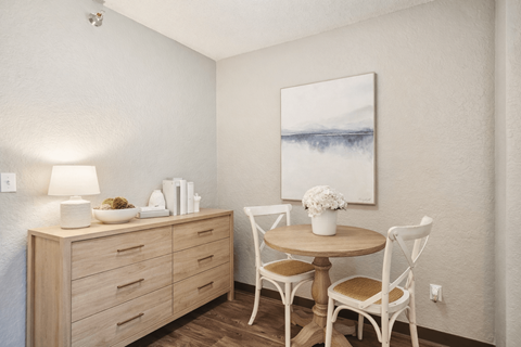 A dining area with a wooden table and chairs.