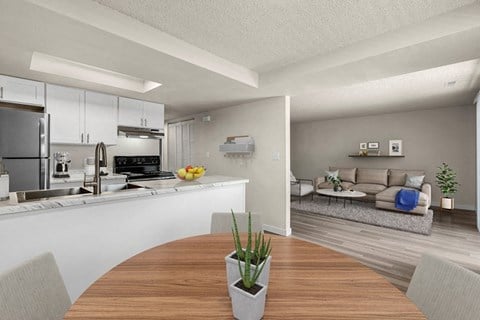 a kitchen and living room with a wooden table