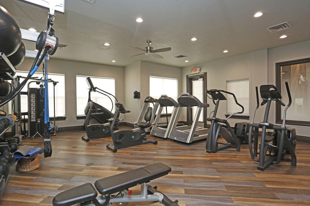 a gym with a lot of exercise equipment.