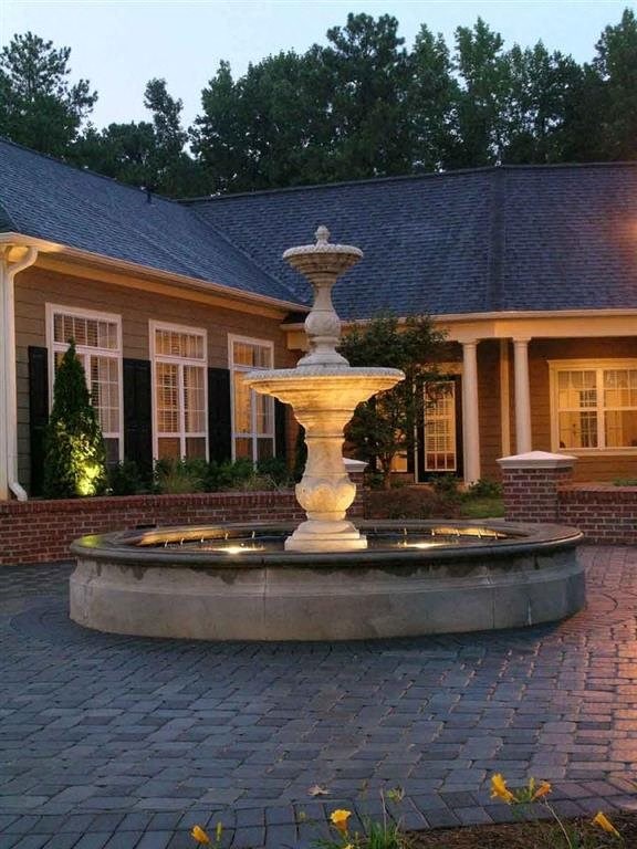 a large fountain in front of a house