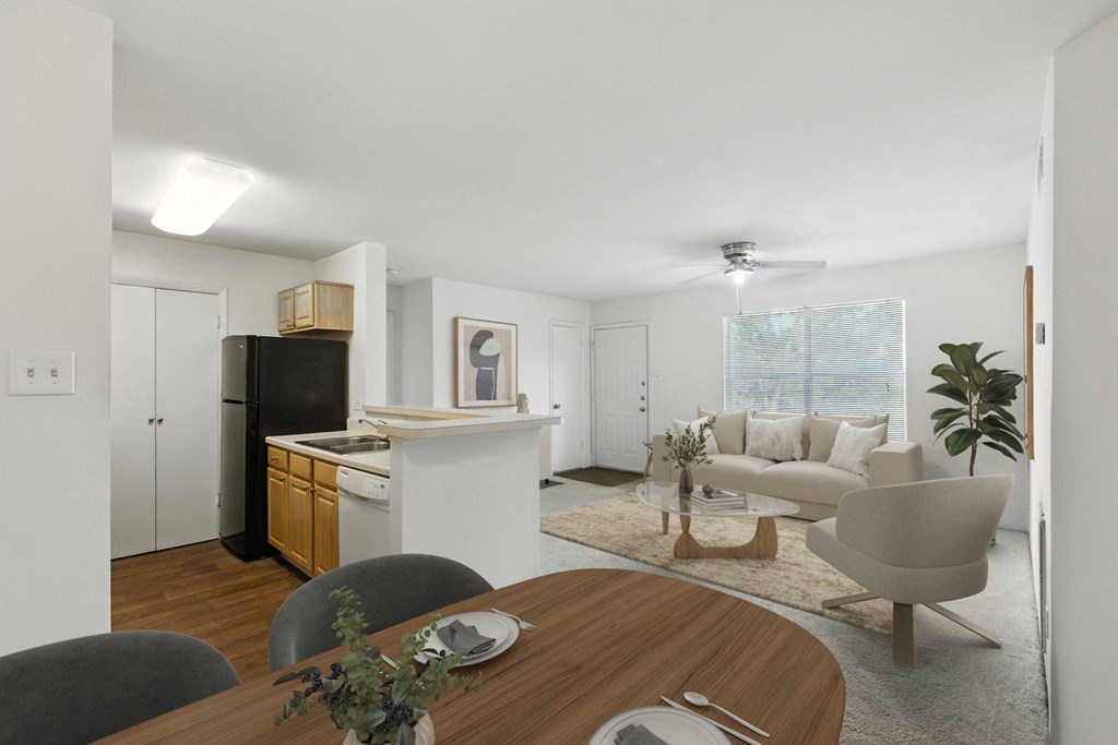 A modern kitchen with a dining table set for two.