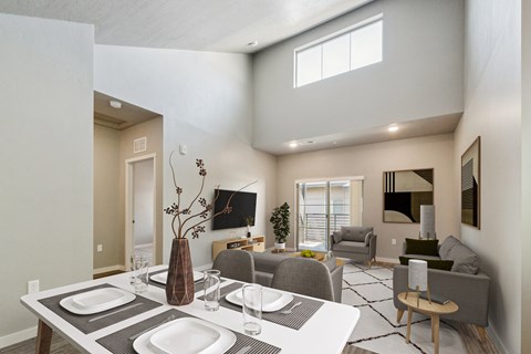 Open concept dining and living area with modern furnishings at Harper Ridge Apartments, Meridian, ID
